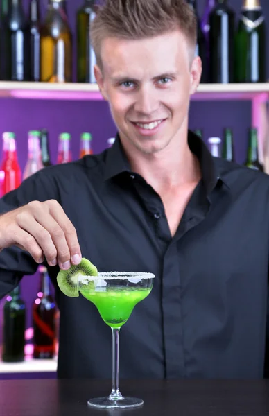 Portrait of handsome barman preparing cocktail, at bar — Stock Photo, Image