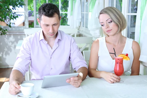Young couple taking with tablet in restaurant — Stock Photo, Image