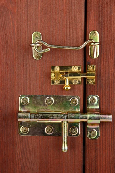 Metal bolts, latches and hooks in wooden door close-up — Stock Photo, Image