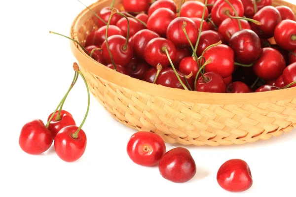 Cherry berries in wicker basket isolated on white — Stock Photo, Image