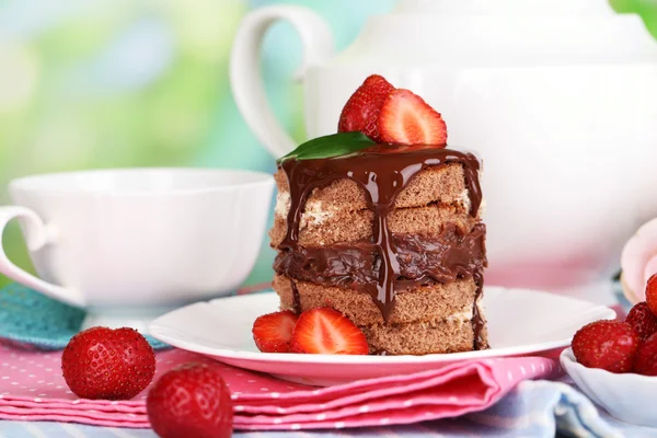 Schokoladenkuchen mit Erdbeere auf Holztisch vor natürlichem Hintergrund — Stockfoto