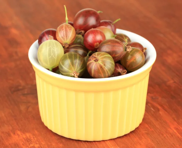 Fresh gooseberries in bowl on table close-up — Stock Photo, Image