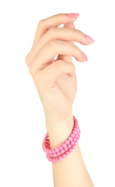 Kvinnlig hand med rosa manikyr och ljusa armband, isolerad på vit — Stockfoto