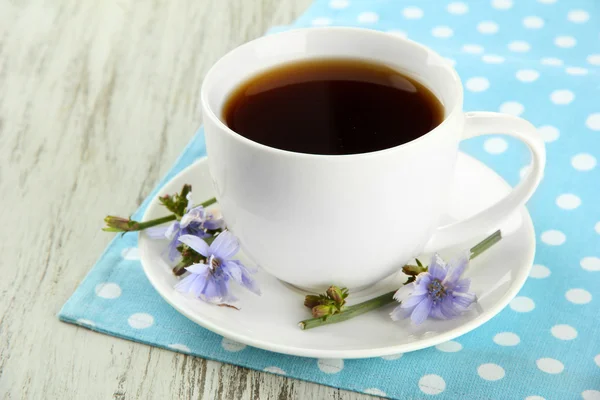 Cup of tea with chicory, on wooden background — Stock Photo, Image