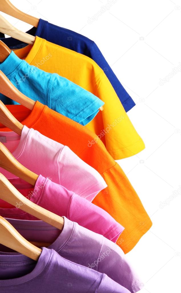 Lots of T-shirts on hangers isolated on white