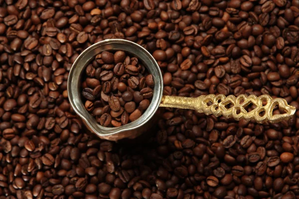 Metal turk on coffee beans background — Stock Photo, Image