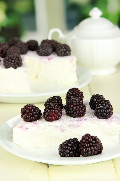 Cheesecake with fresh berries on white plate on wooden table — Stock Photo, Image