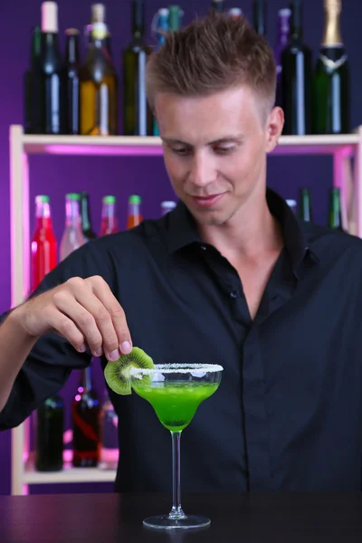 Portrait of handsome barman preparing cocktail, at bar — Stock Photo, Image