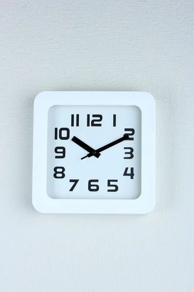 Office clock on color wall background — Stock Photo, Image