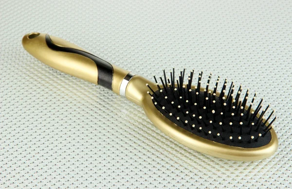 Hairbrush on color background — Stock Photo, Image