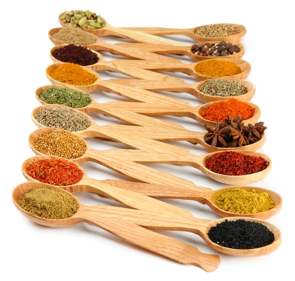 Assortment of spices in wooden spoons, isolated on white — Stock Photo, Image