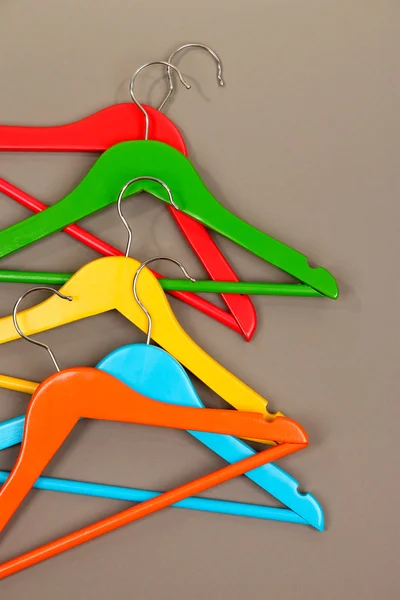 Colorful clothes hangers on gray background — Stock Photo, Image