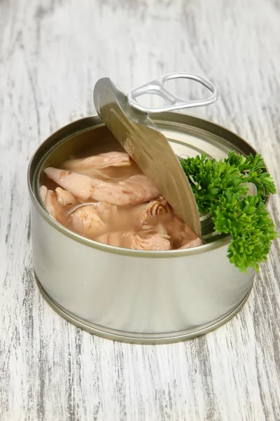 Open tin can, on wooden background — Stock Photo, Image