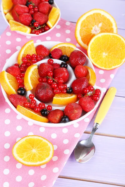 Useful fruit salad in plates on wooden table close-up — Stock Photo, Image