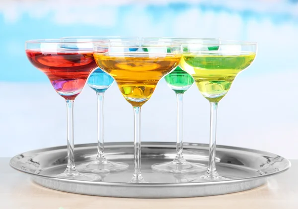 Different cocktails on bright background — Stock Photo, Image