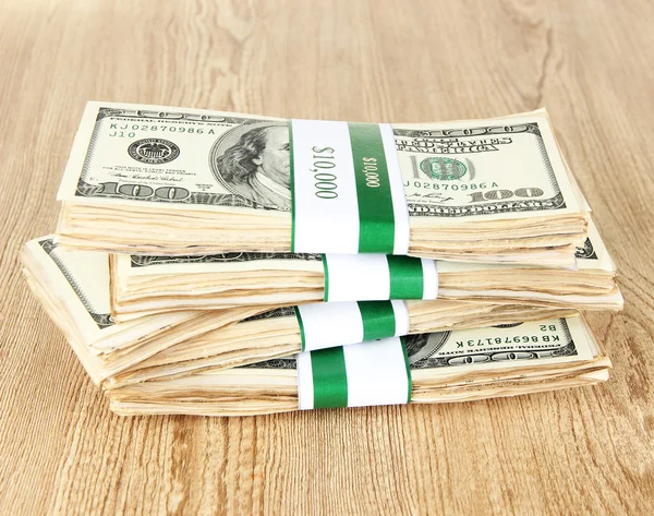 Stacks of money on wooden table — Stock Photo, Image