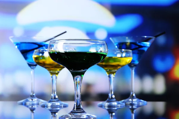 Glasses of cocktails on bright background — Stock Photo, Image