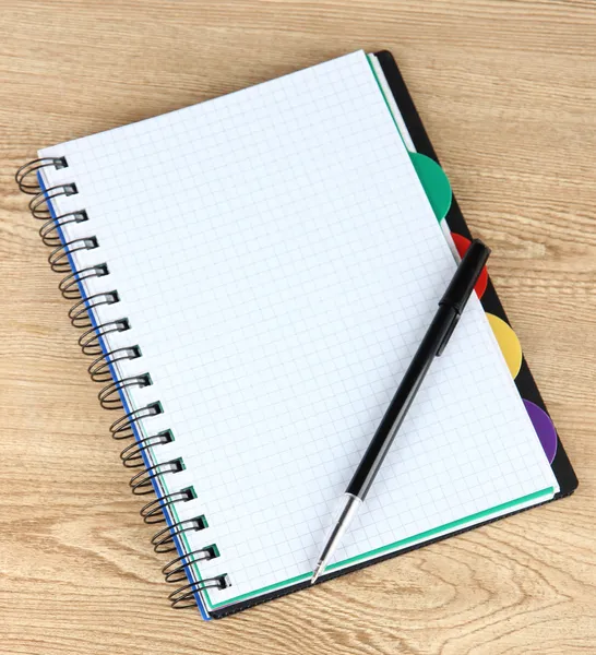 Notebook and pen on wooden table — Stock Photo, Image