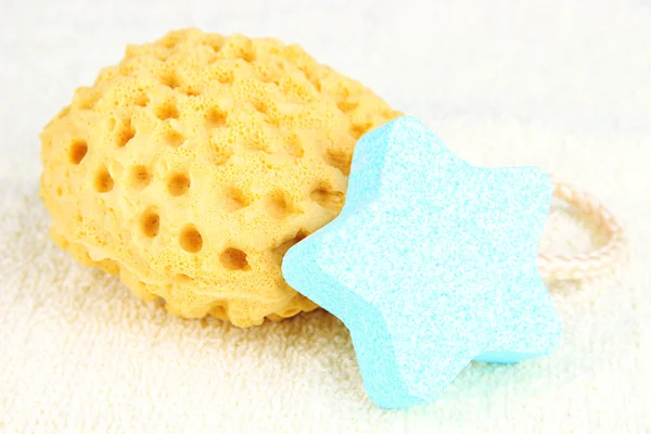 Sea salt and sponge for bathing, on color towel background — Stock Photo, Image