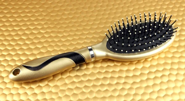 Hairbrush on color background — Stock Photo, Image