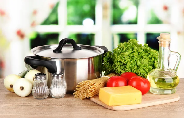 Ingredients for cooking pasta on table in kitchen — Stock Photo, Image