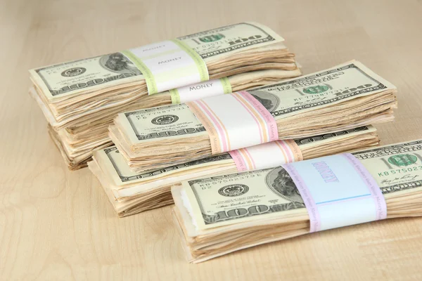 Stacks of money on wooden table — Stock Photo, Image