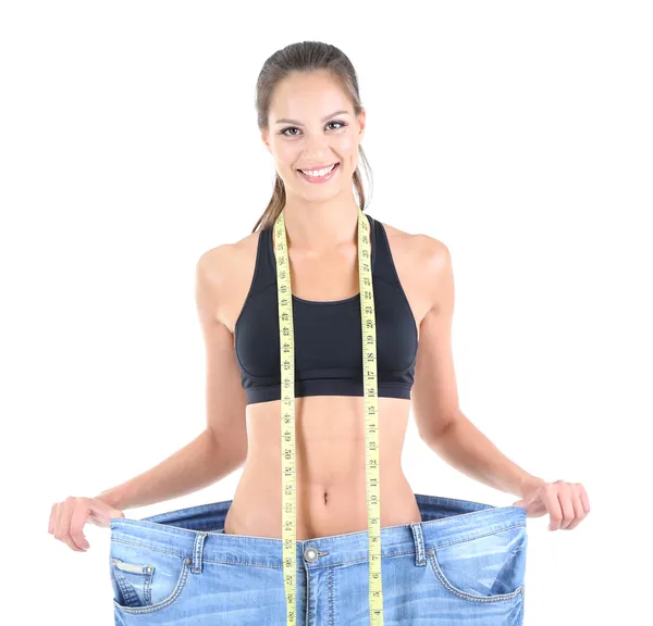 Slim girl in big jeans isolated on white — Stock Photo, Image