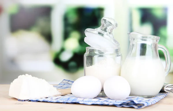 Ingredients for dough on wooden table on window background — Stock Photo, Image