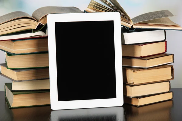 Tablet e libri su sfondo chiaro — Foto Stock