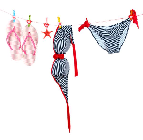 Women's swimsuit and flip-flops hanging on a rope