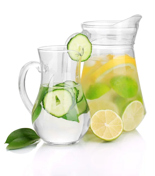 Cold water with lemon, cucumber and ice in pitchers isolated on white — Stock Photo, Image