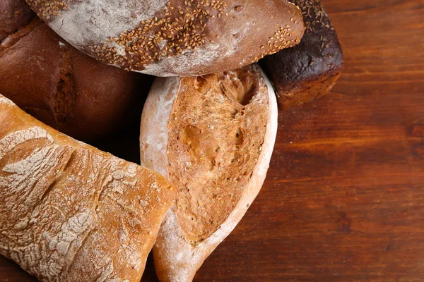 Much bread on wooden board — Stock Photo, Image