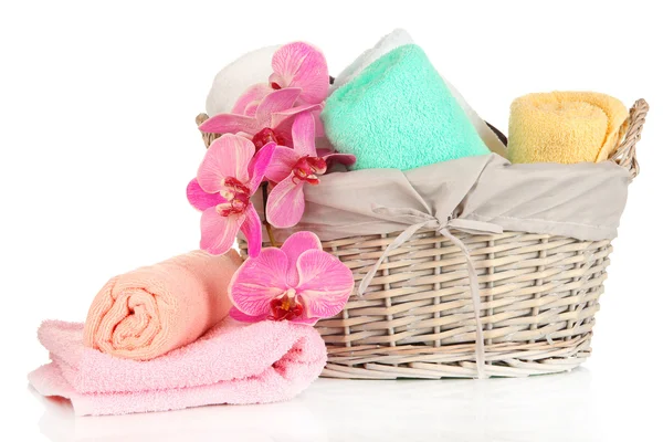 Bathroom towels folded in wicker basket isolated on white — Stock Photo, Image