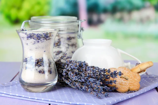 Jar of lavender sugar and fresh lavender flowers on bright background — Stock Photo, Image