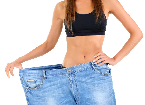 Slim girl in big jeans — Stock Photo, Image