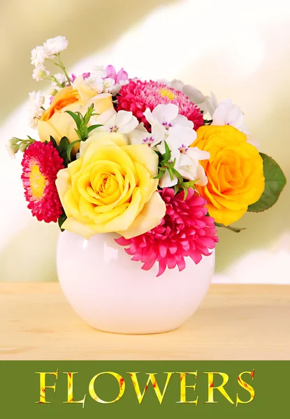 Beautiful bouquet of bright flowers in vase on bright background — Stock Photo, Image