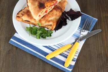 Pizza calzone peçete ahşap masa üzerinde plaka üzerinde