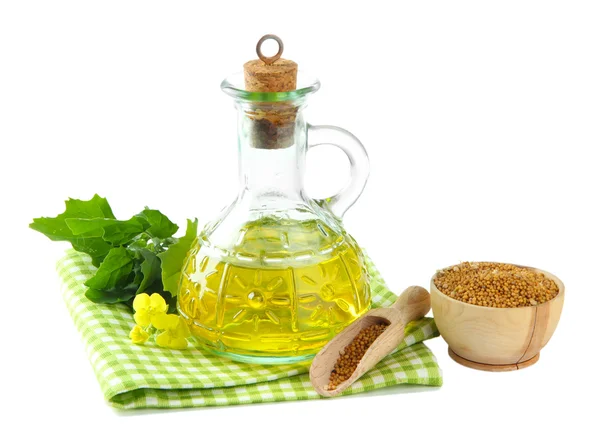 Jar of mustard oil and seeds with mustard flower on wooden background — Stock Photo, Image