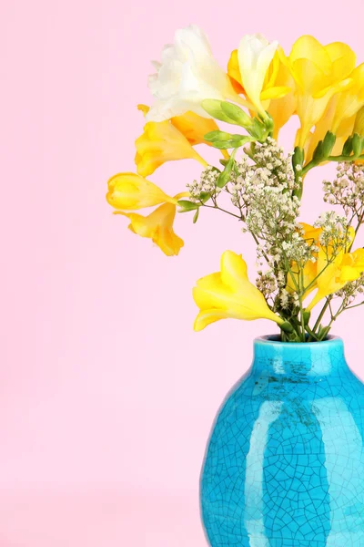 Beautiful bouquet of freesia in vase on pink background — Stock Photo, Image