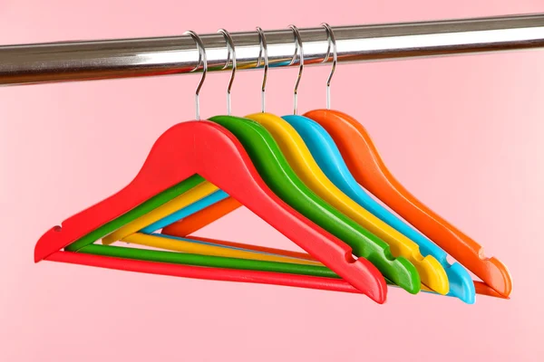 Colorful clothes hangers on pink background — Stock Photo, Image