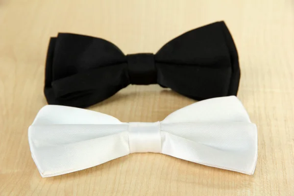 Black and white bow ties on wooden background — Stock Photo, Image