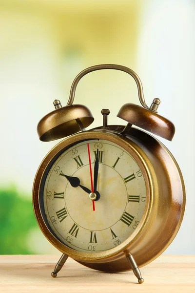 Old alarm clock on bright background Stock Picture