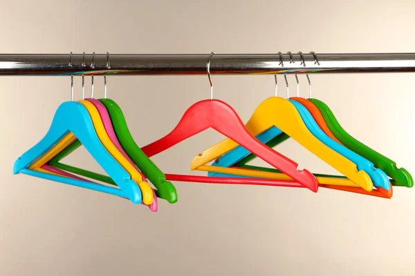 Colorful clothes hangers on gray background — Stock Photo, Image