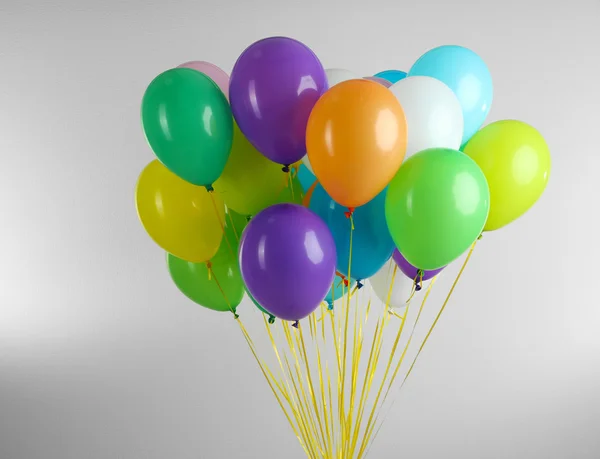 Colorful balloons on grey background — Stock Photo, Image