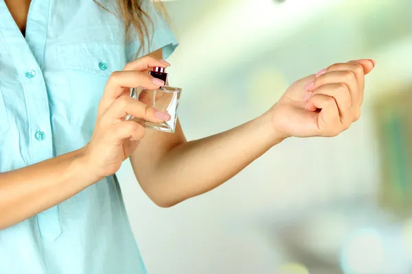 Mulher testando perfume em fundo natural — Fotografia de Stock