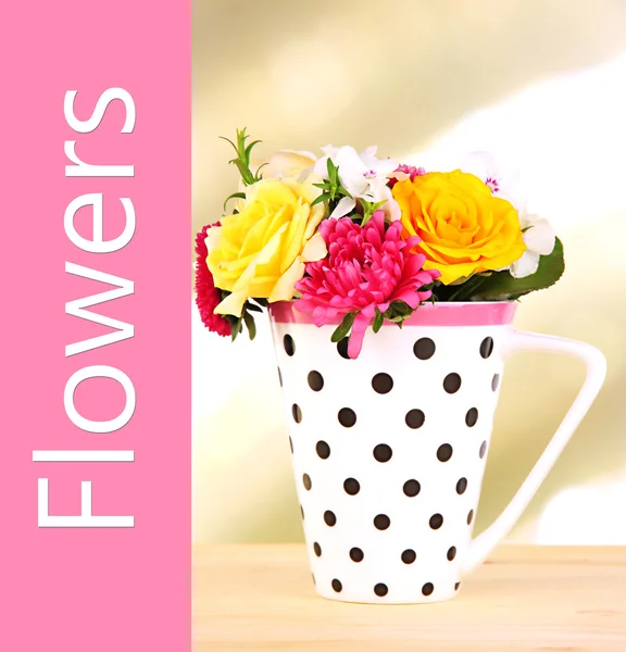 Beautiful bouquet of bright flowers in mug on bright background — Stock Photo, Image