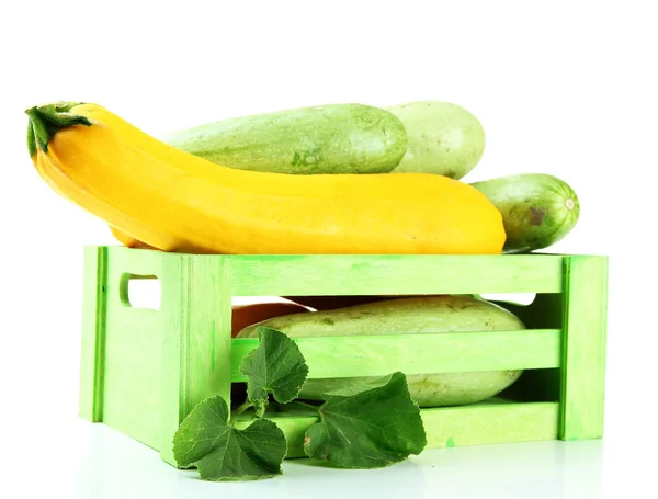 Raw yellow and green zucchini in wooden crate, isolated on white — Stock Photo, Image