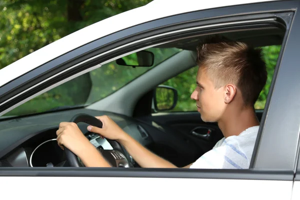 Young man in his new car Stock Photo