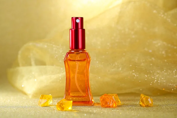 Women perfume in beautiful bottle on orange background — Stock Photo, Image