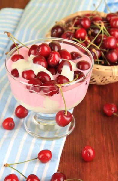 Delicious cherry dessert in glass vase on wooden table close-up — Stock Photo, Image